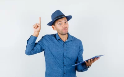 Person in blue shirt and hat holding clipboard, raising one finger.